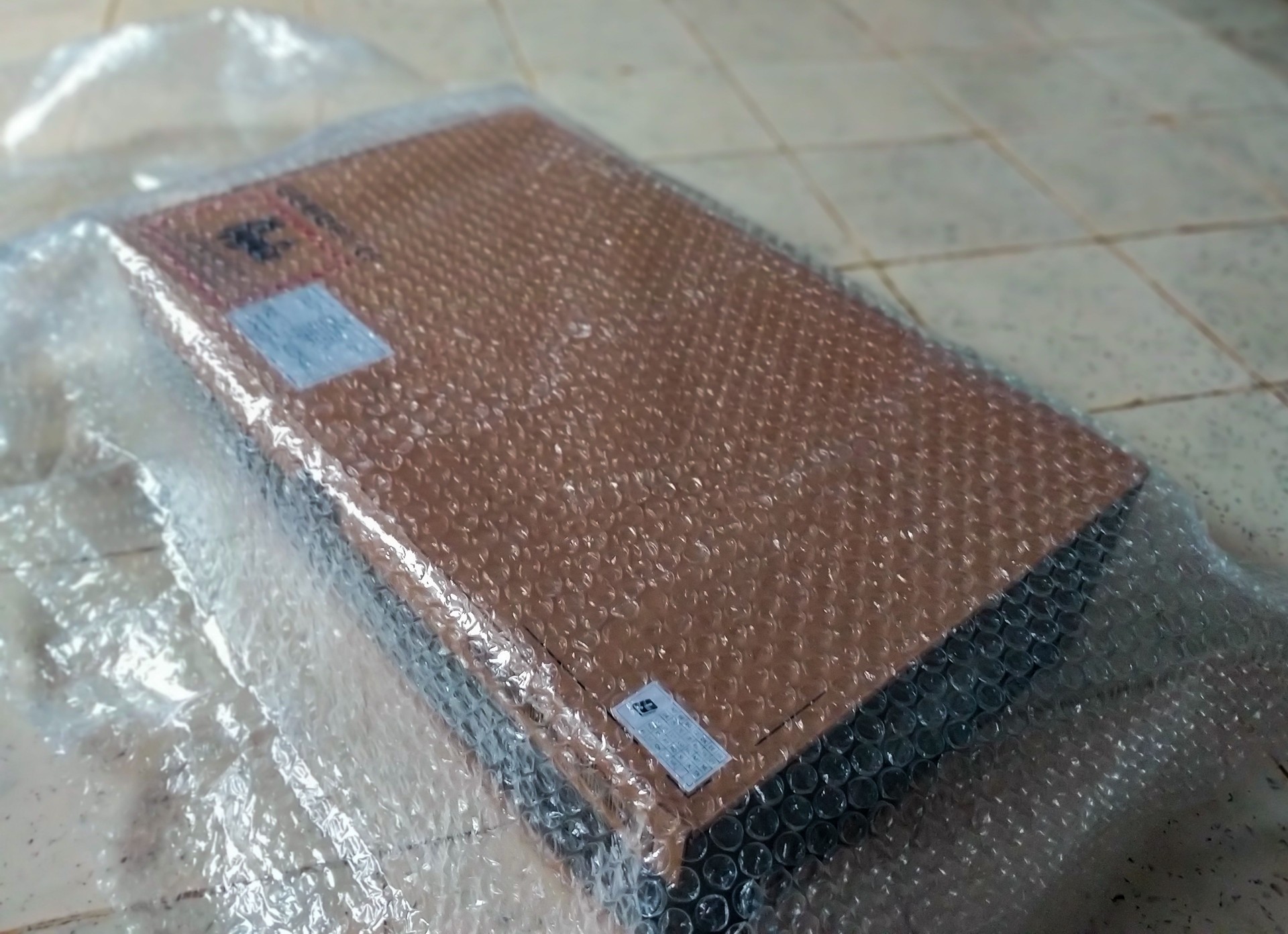 brown cardboard box wrapped in bubble wrap